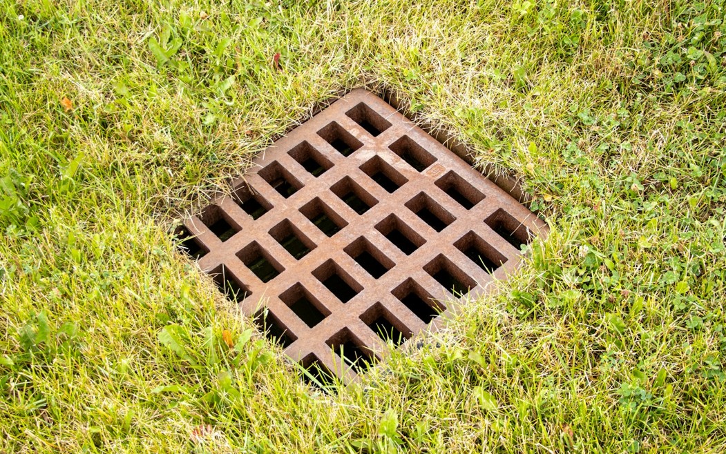 worker cleaning out guttering