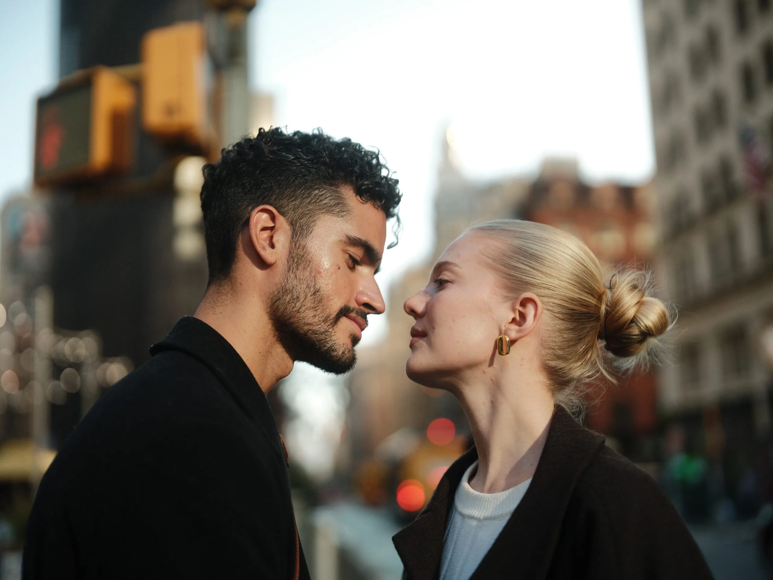 Juan and Rhylan turned toward each other on a Midtown corner, taxis blurred behind them.