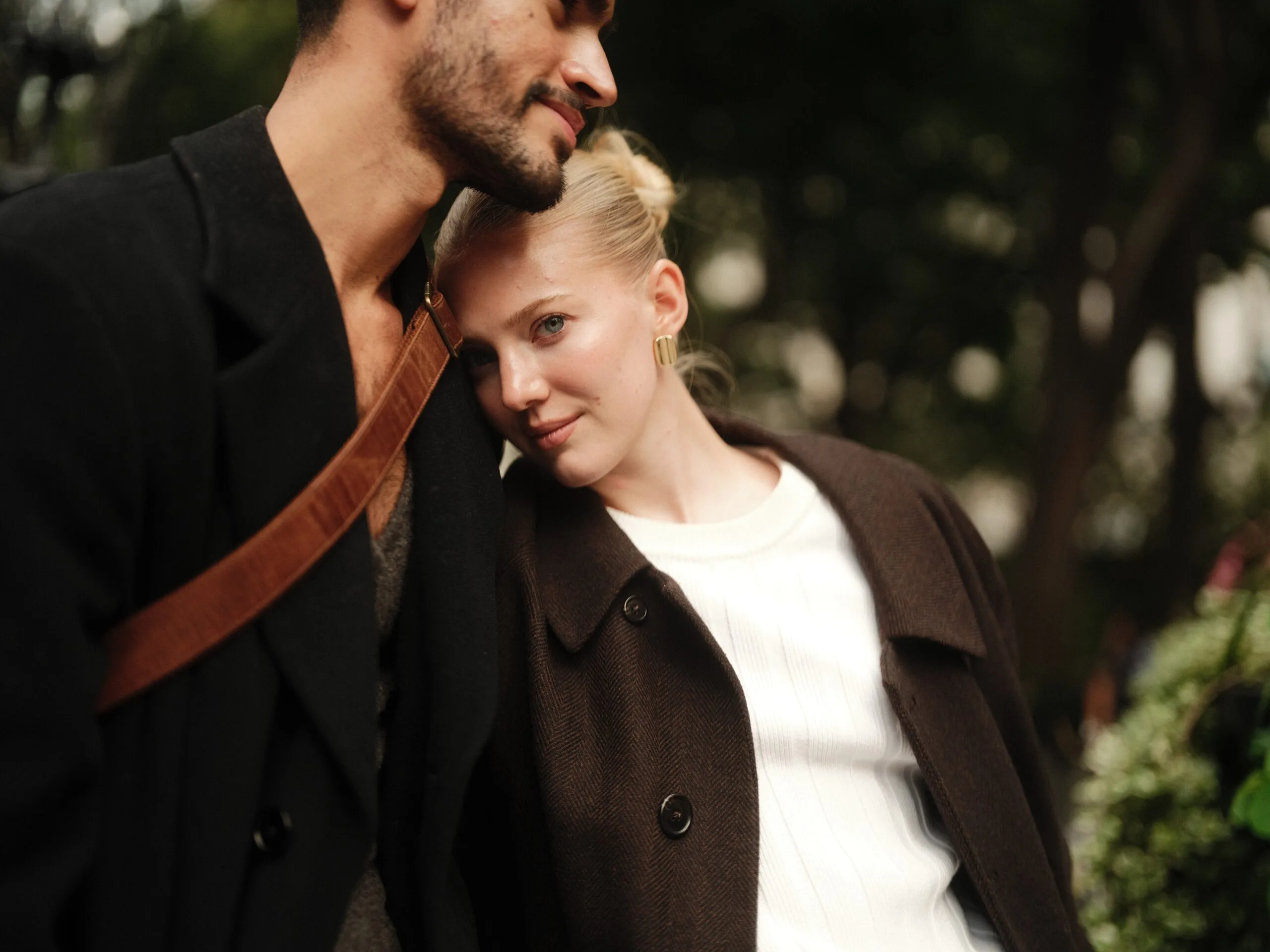 A tender black and white profile — Juan and Rhylan close, cheek to cheek.