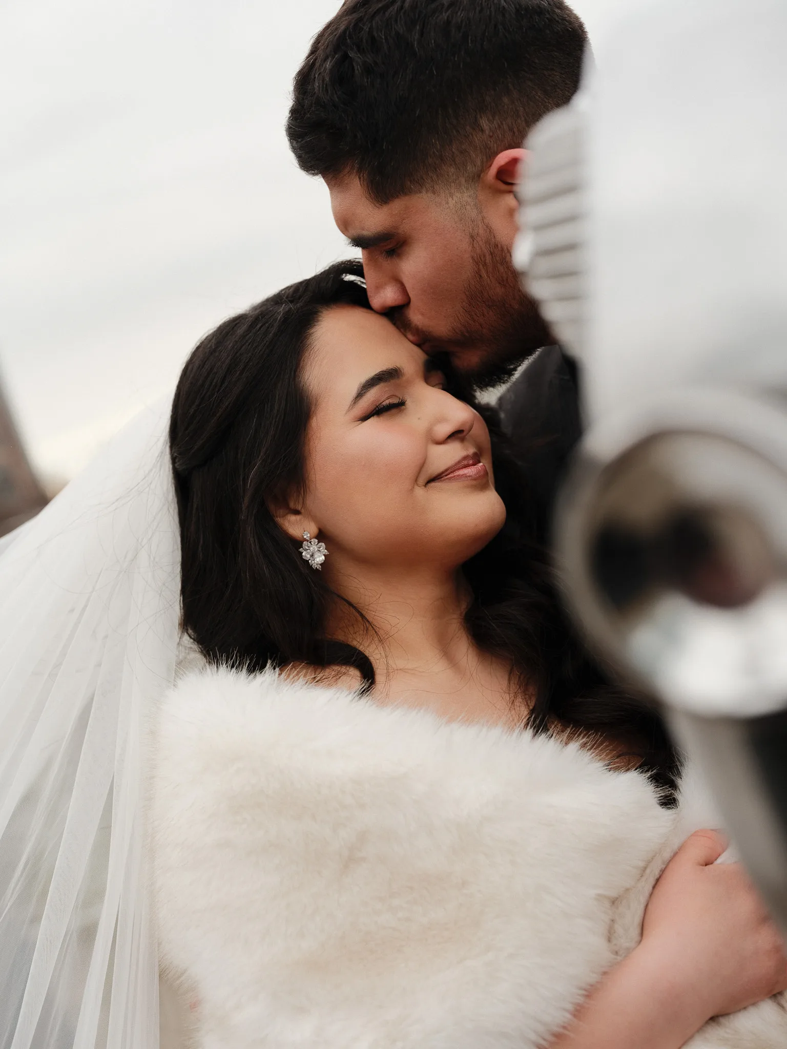 A quiet moment — a forehead kiss, through the viewfinder.