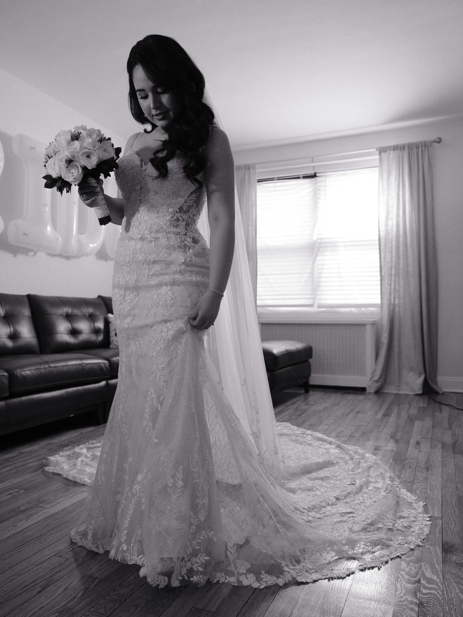 Scarlett in her wedding dress, holding her bouquet, the long veil pooling on the floor.