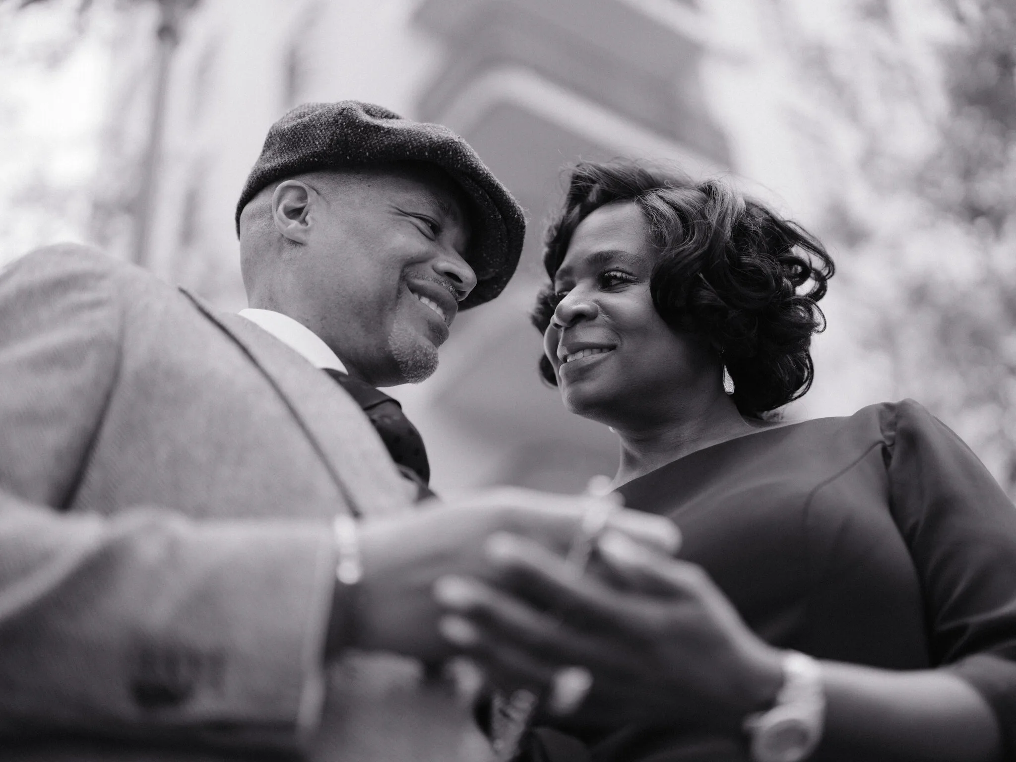 Marc and Olgeta walking hand in hand into the fading light, the Dumbo skyline behind them — a long-marriage portrait that still has chapters to come.