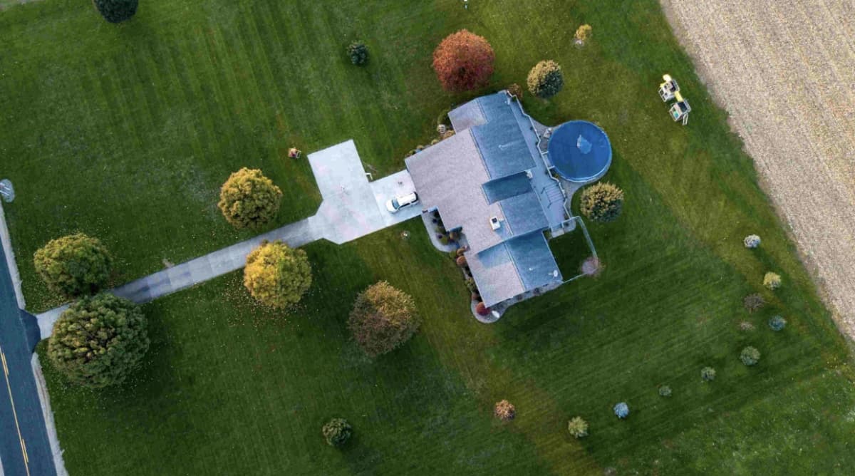 Aerial residential property photography showing house and surrounding neighborhood context