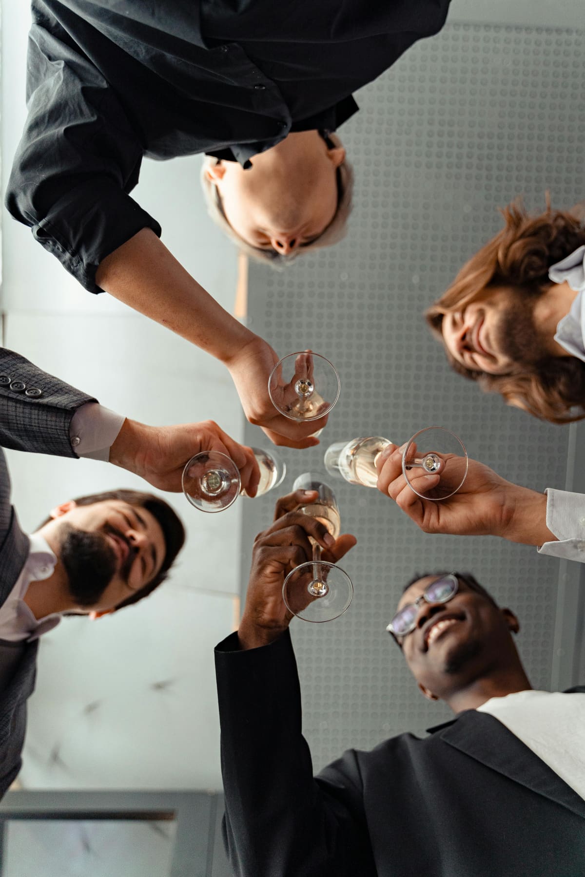 Group of business professionals toasting with champagne glasses at corporate event