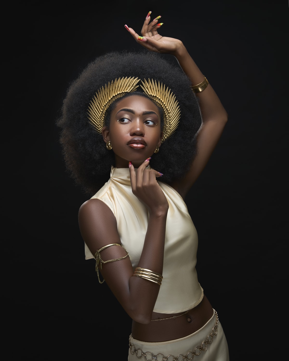 Gold headpiece and neutral fashion styling in a dramatic portrait