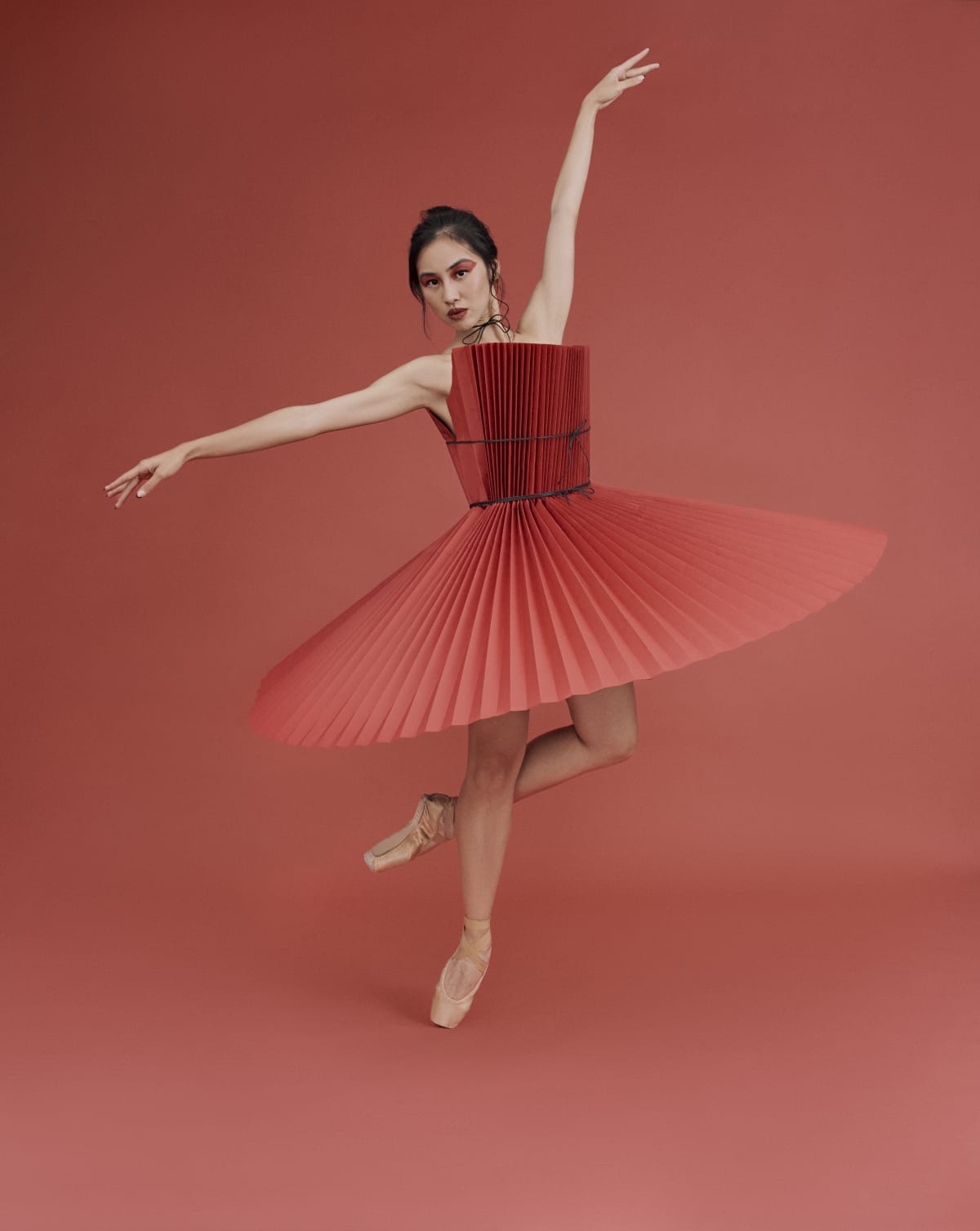 Red sculptural dress styled for a fashion editorial
