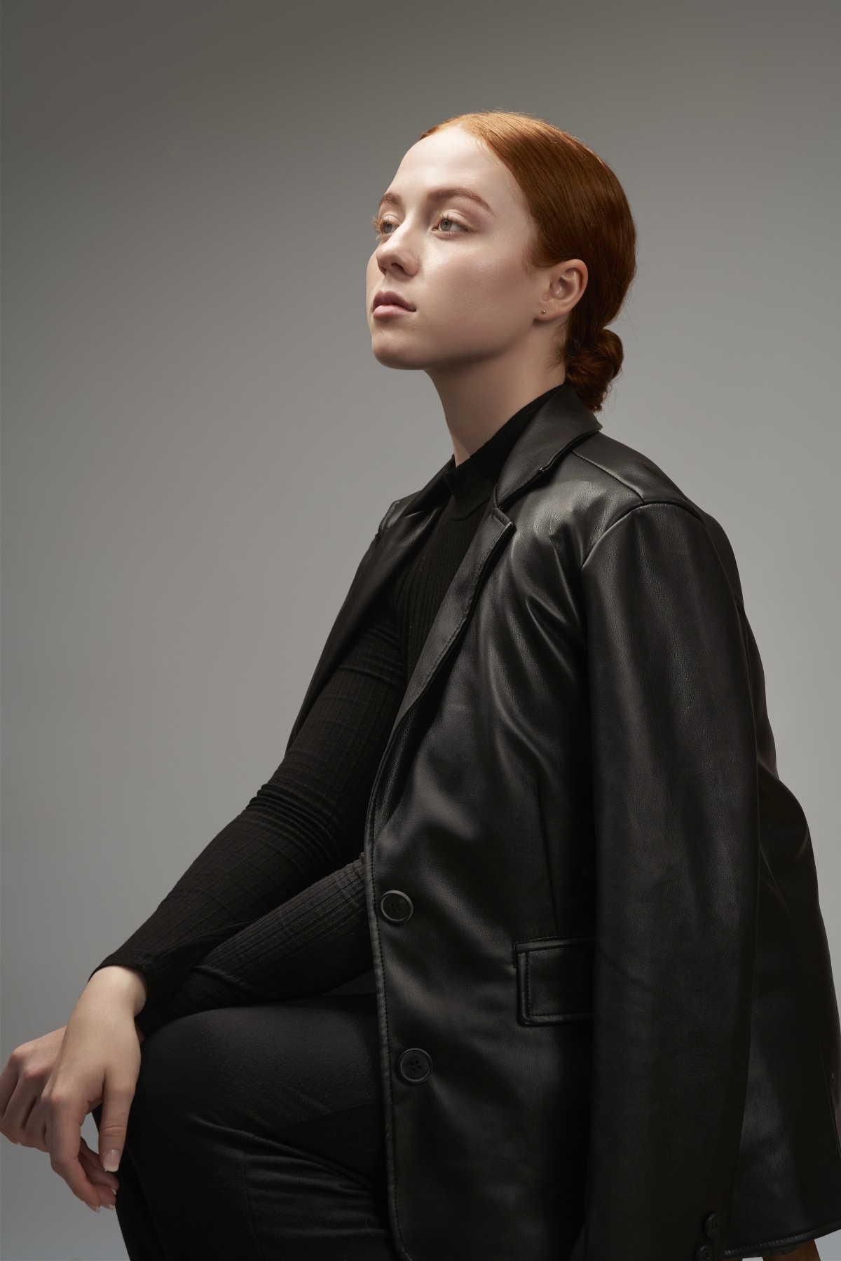 Minimal black fashion look styled for a studio portrait