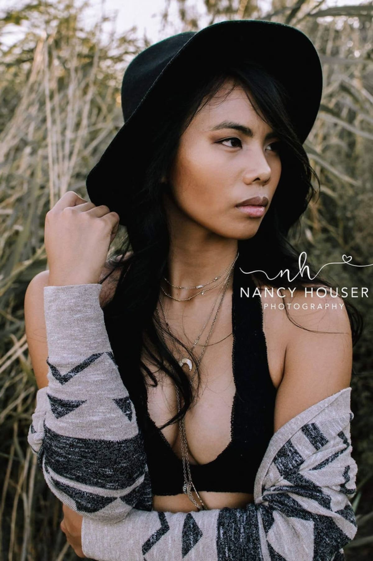 Layered outdoor fashion portrait with a wide-brim hat