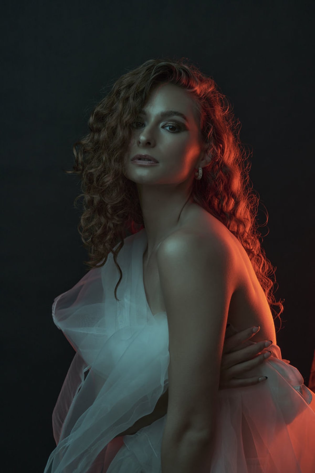 Fashion portrait with dramatic red and blue lighting