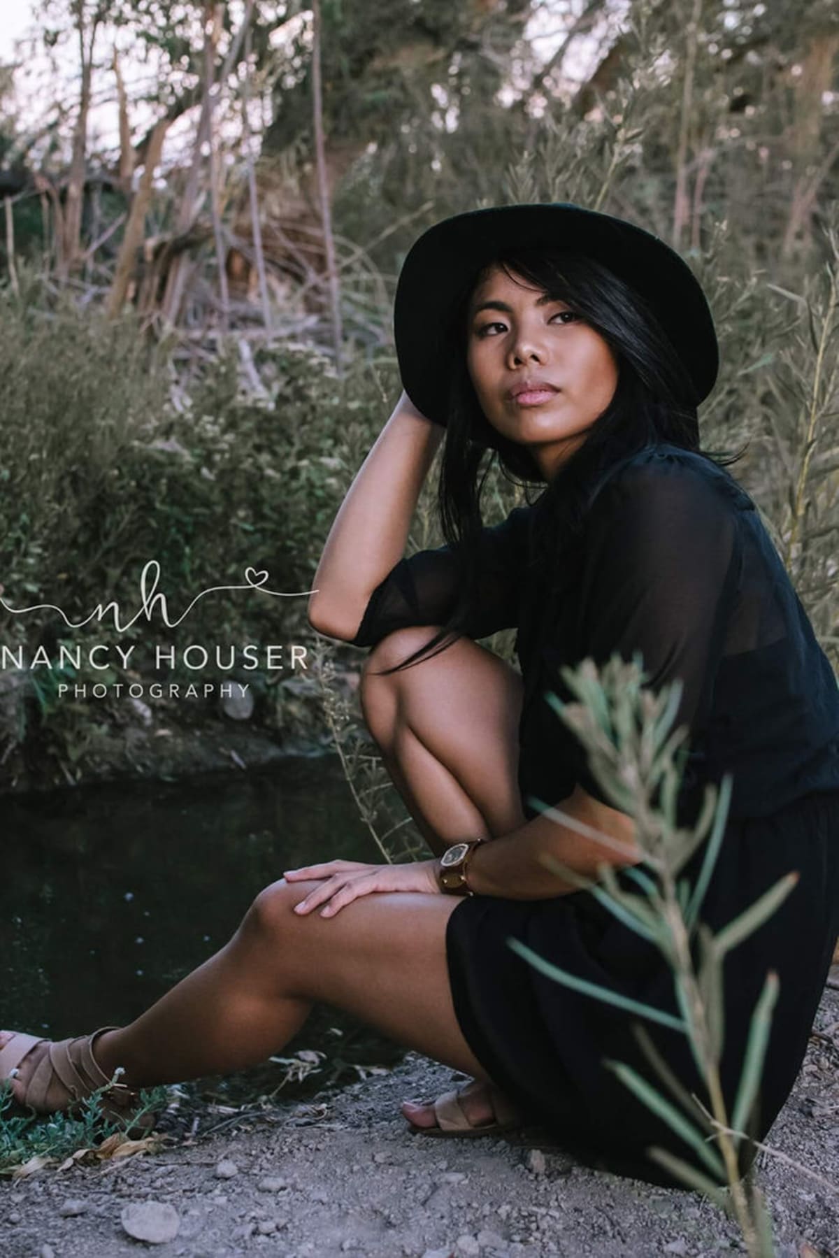 Black dress and wide-brim hat styled for an outdoor portrait