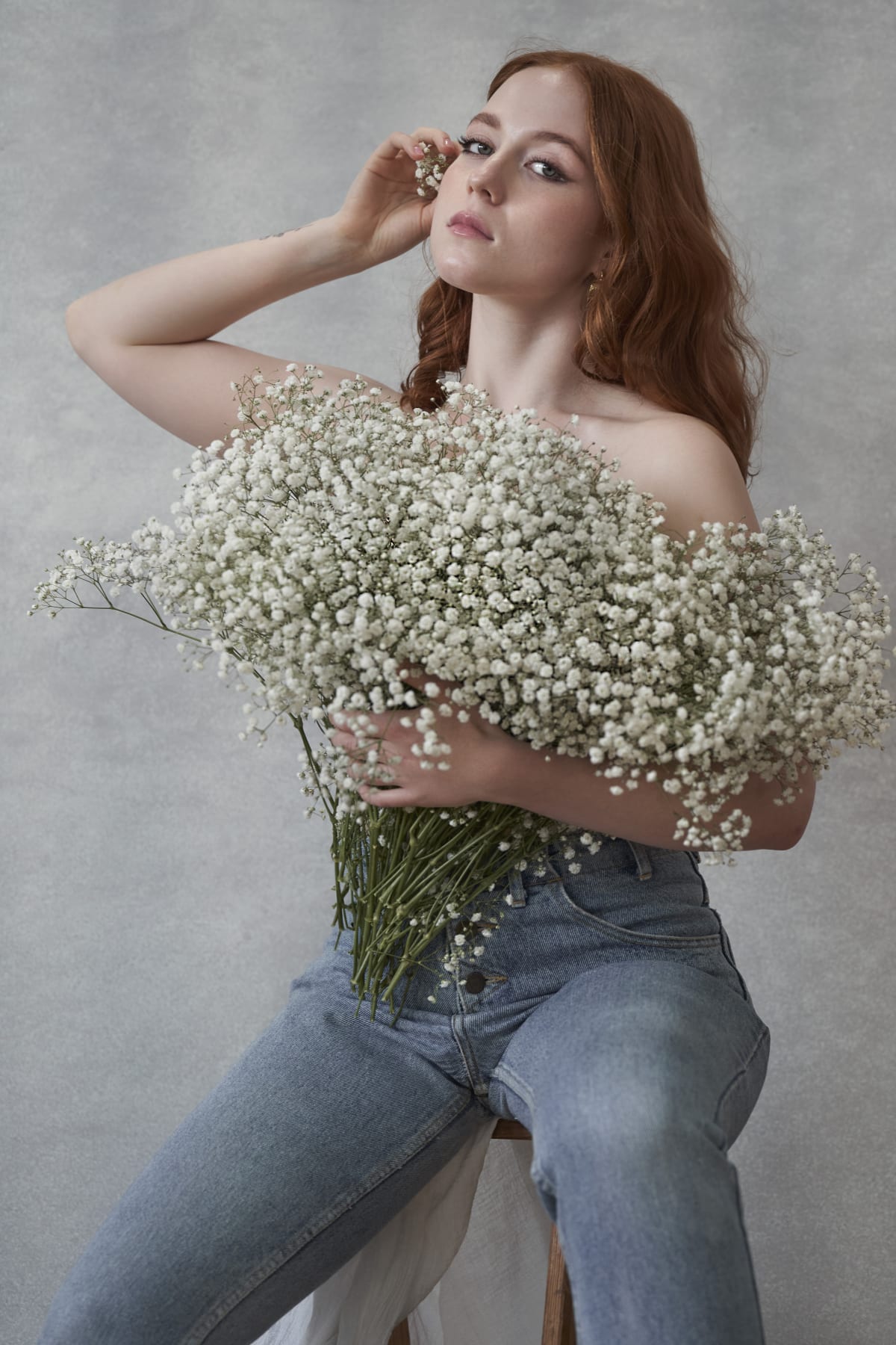 Fashion portrait with flowers, denim, and delicate jewelry