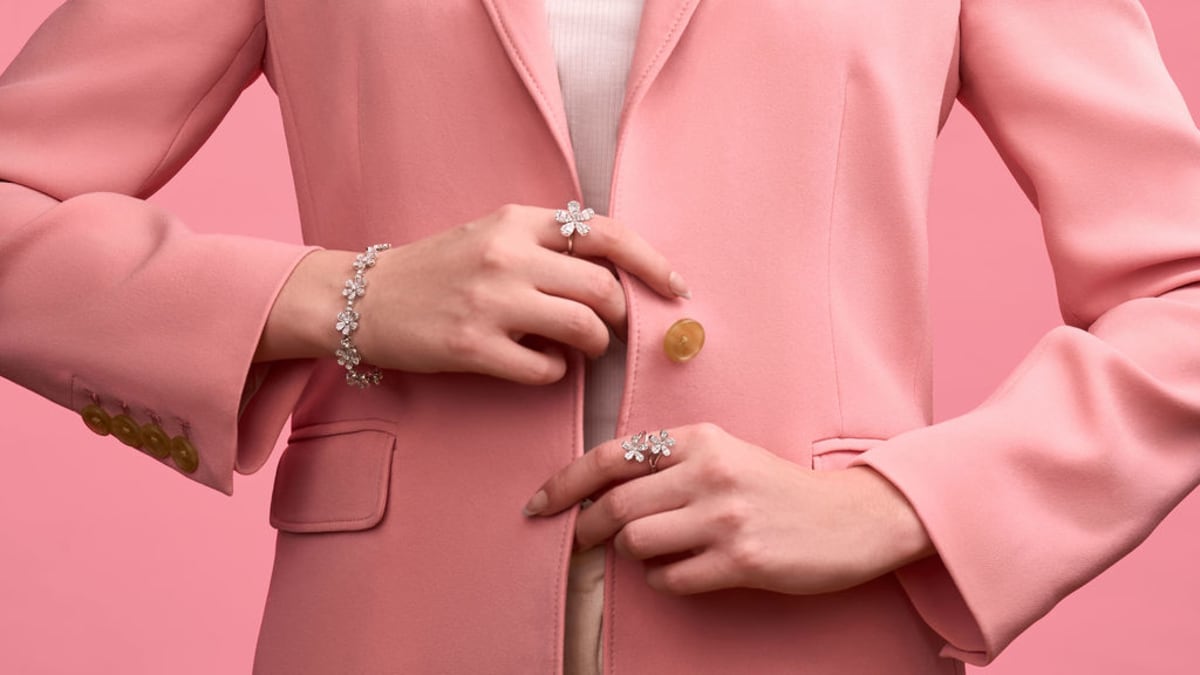 Pink blazer and jewelry detail from a styled campaign