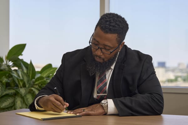 Attorney working on laptop with focus NYC law firm office photography
