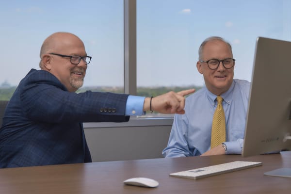 Two attorneys collaborating and pointing NYC law firm office lifestyle photography