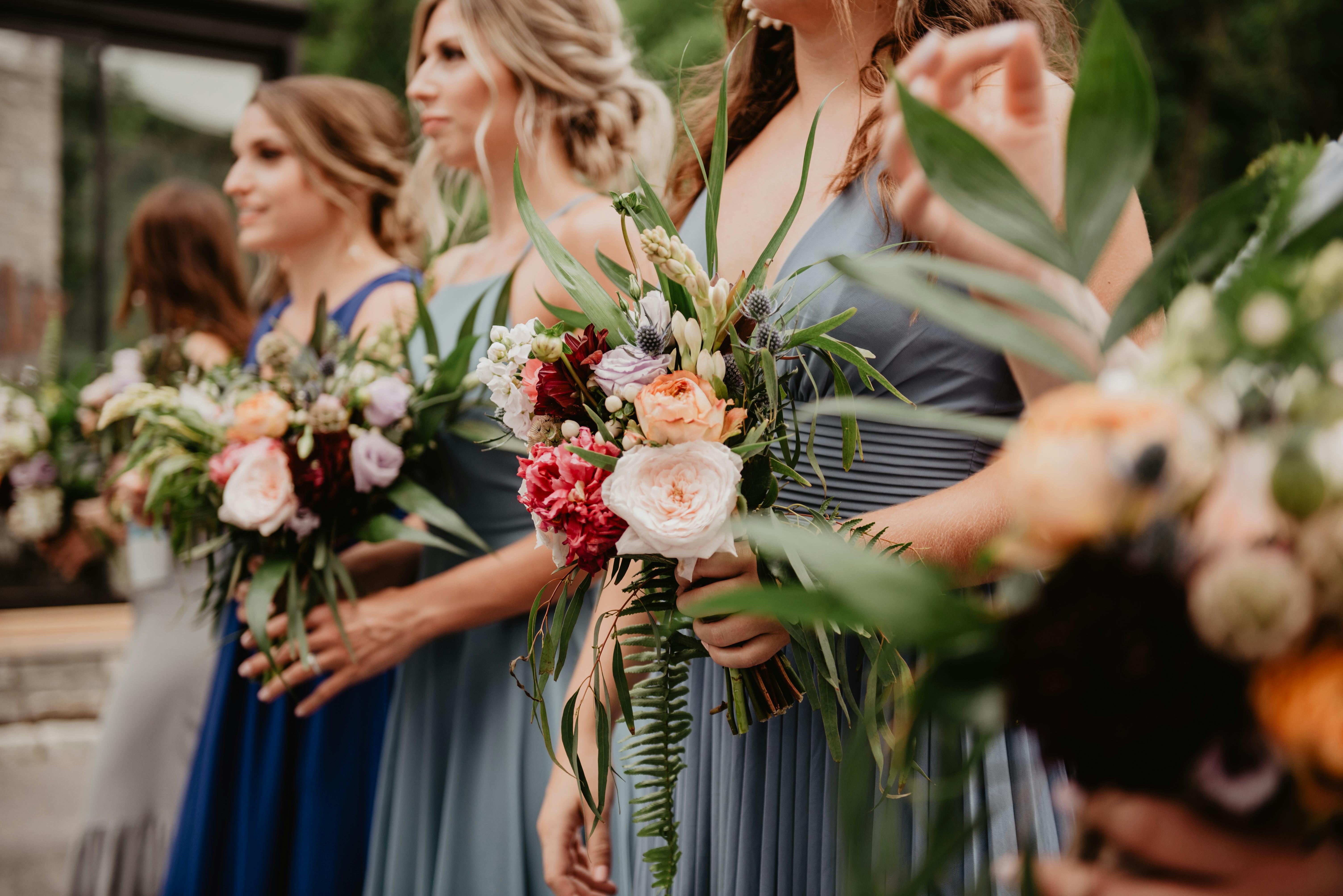 Wedding party bridesmaids in blue dresses with floral bouquets - professional event photography NYC