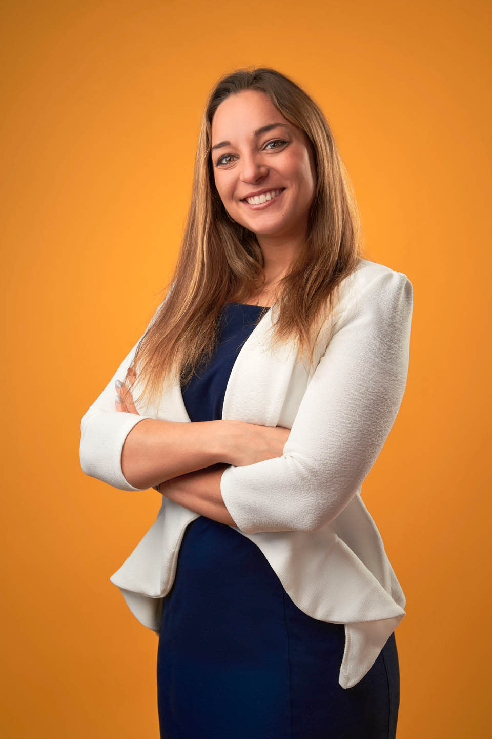 Professional real estate agent portrait with energetic yellow background corporate branding NYC