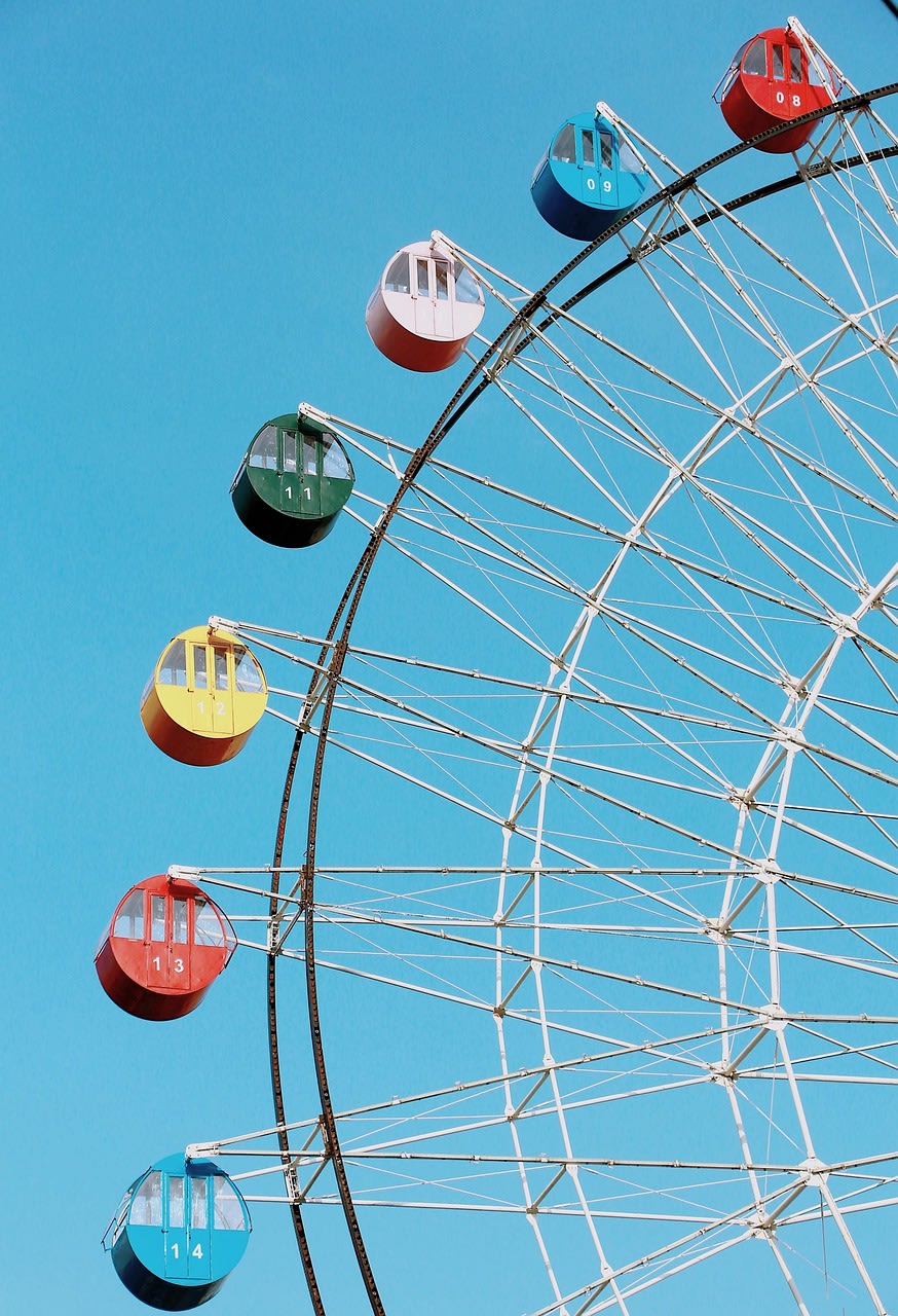 Colorful ferris wheel with pastel cabins showing how different colors can flow together harmoniously in corporate branding