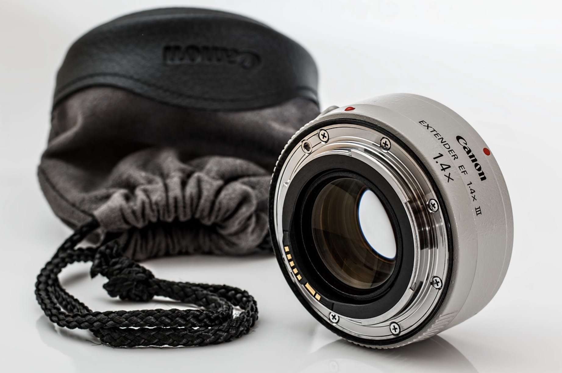 Camera lens packed in protective case alongside SSDs and gear before a video production shoot