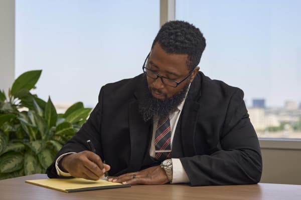 Attorney working on laptop with focus NYC law firm office photography