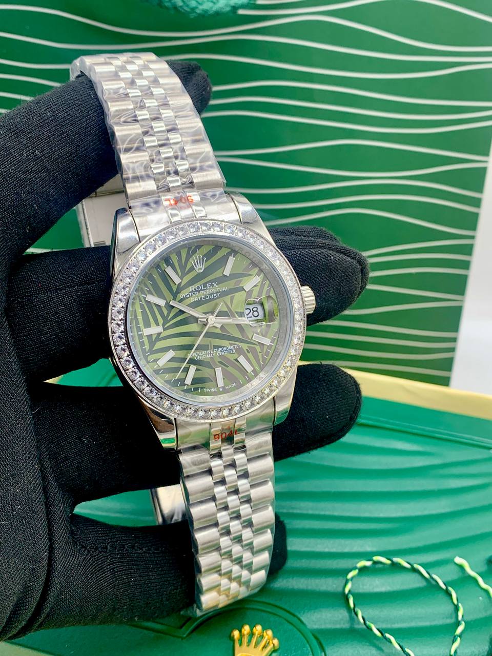 This is a Rolex Datejust (with a diamond bezel and green palm-style dial) 1