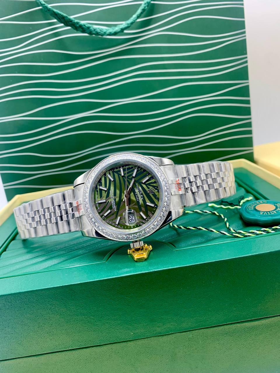 This is a Rolex Datejust (with a diamond bezel and green palm-style dial) 2