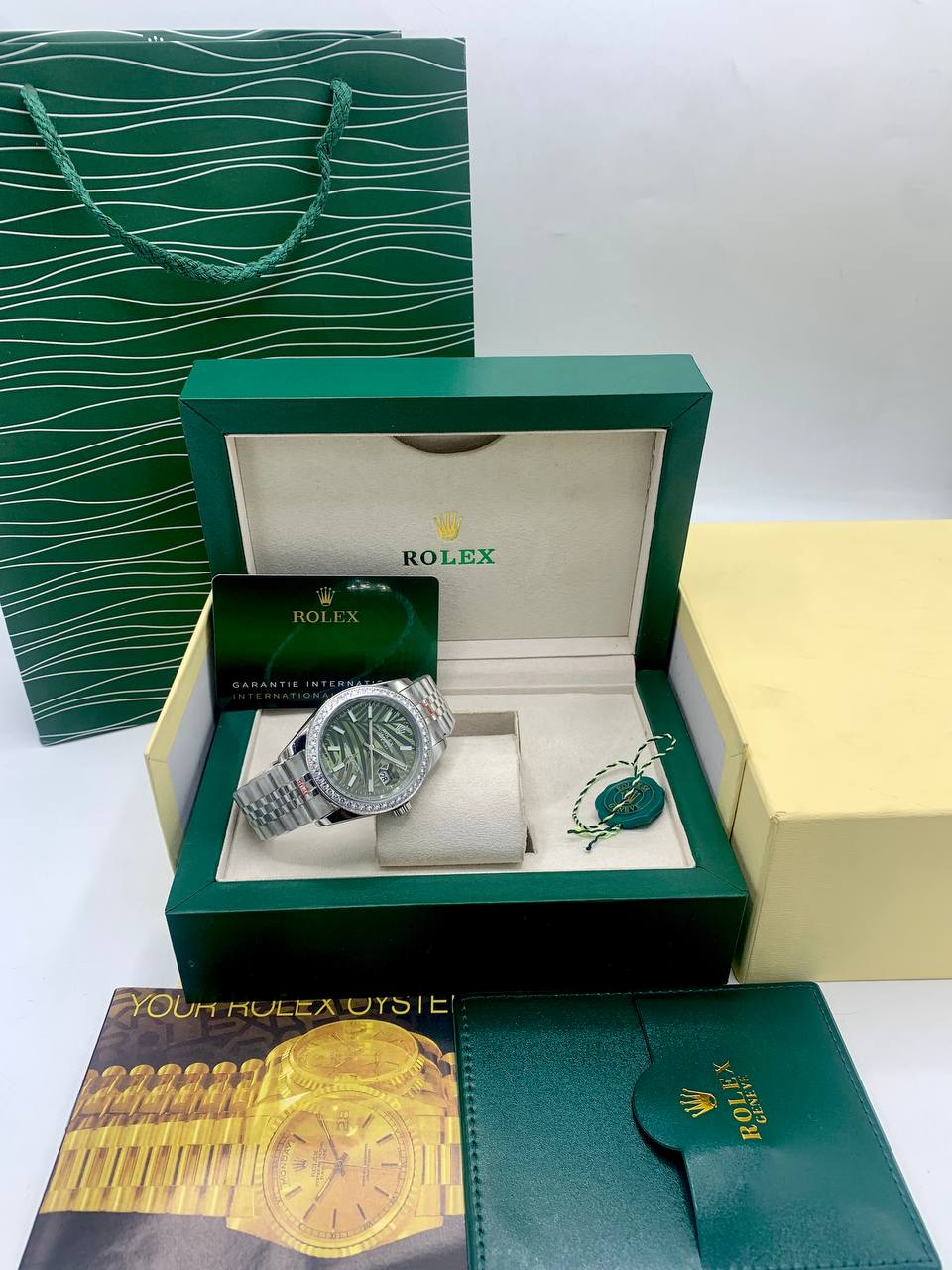 This is a Rolex Datejust (with a diamond bezel and green palm-style dial) 3