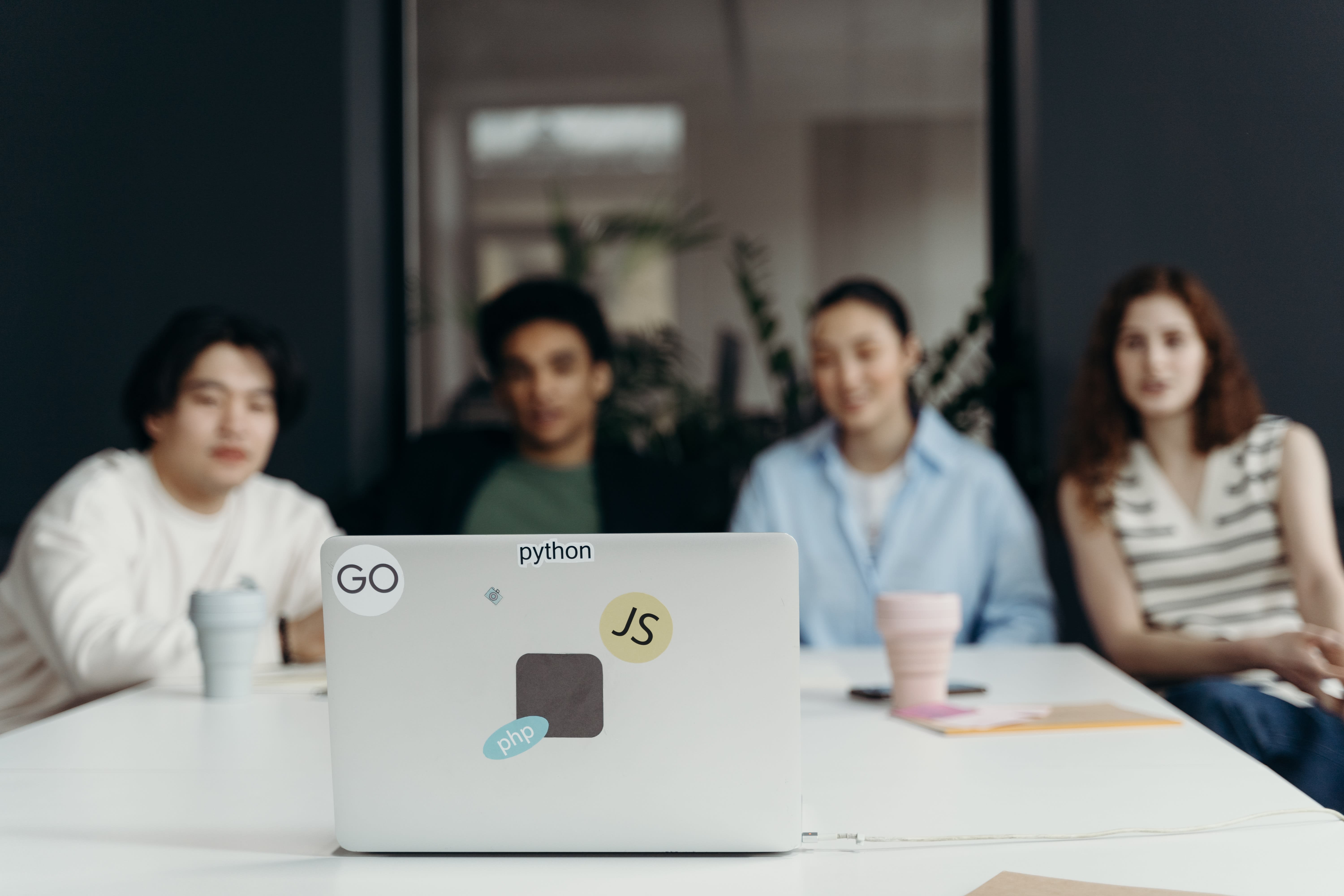 A group of people looking at a laptop during a meeting