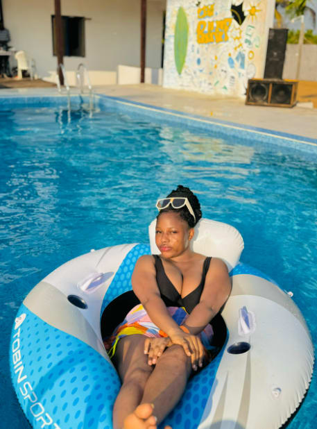 Guest relaxing on a float in a turquoise pool