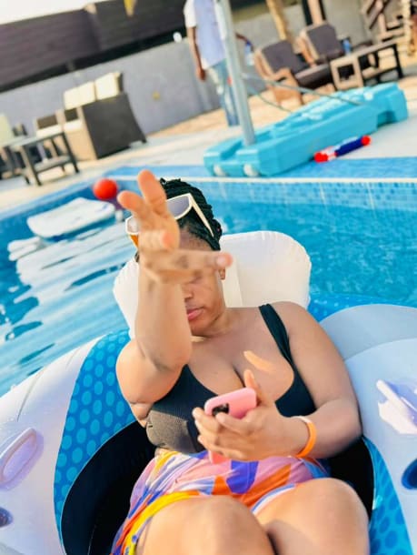 A playful poolside moment on an inflatable float