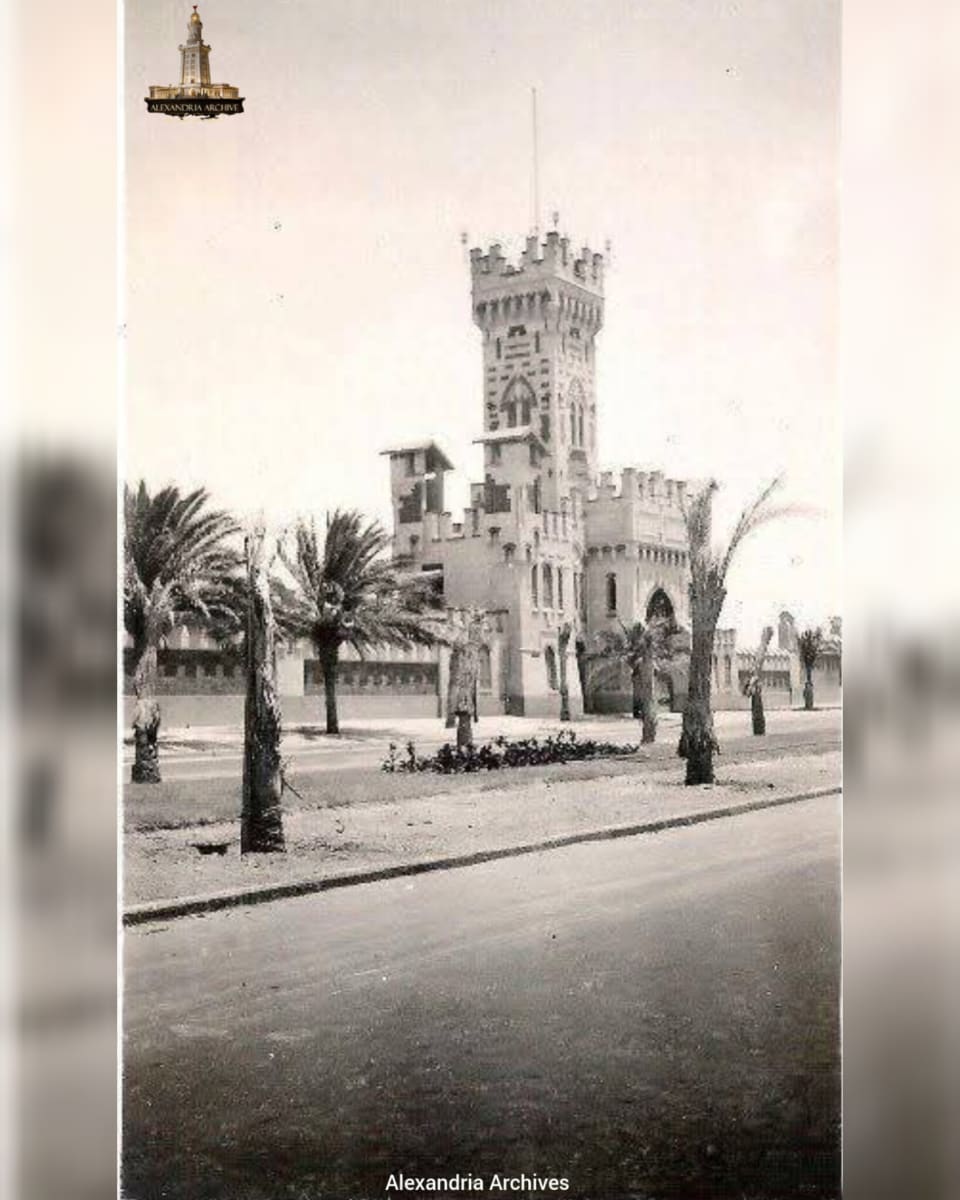 A photograph taken in front of the gate of the historic Montazah Gardens in Alexandria. This gate was built within the Montazah Royal Palace complex, which was constructed as a royal resort in 1892. 