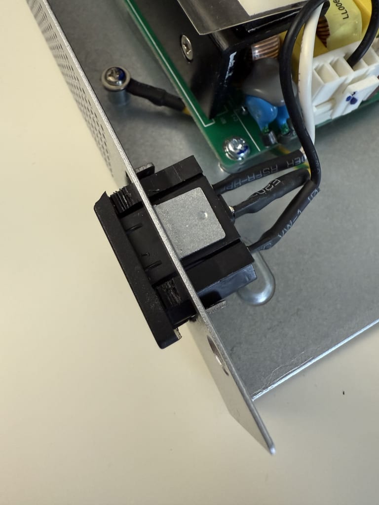Pushing the tabs and sliding the port out