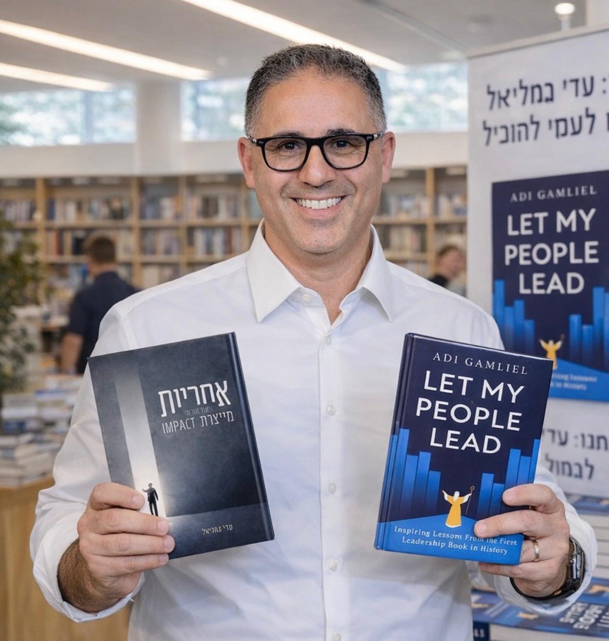 Adi Gamliel holding books