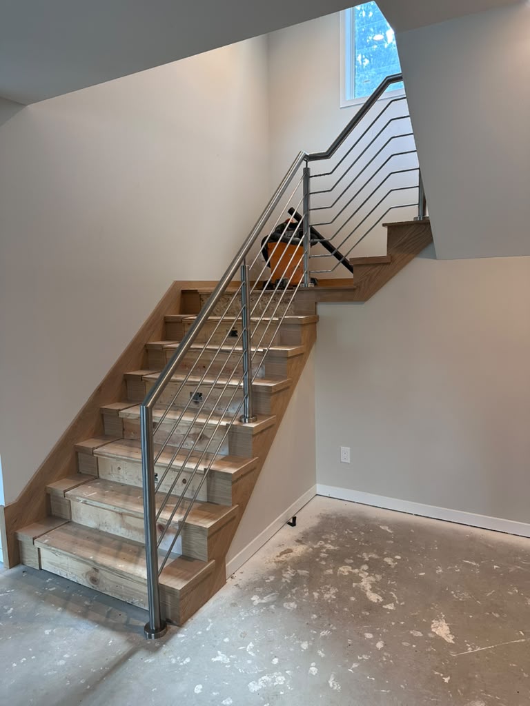 Interior metal railing on basement stairs, custom built by Hot Fab Welding in Metro Detroit