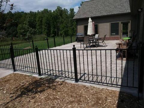 Decorative iron porch railings at a front entry, fabricated by Hot Fab Welding in Michigan