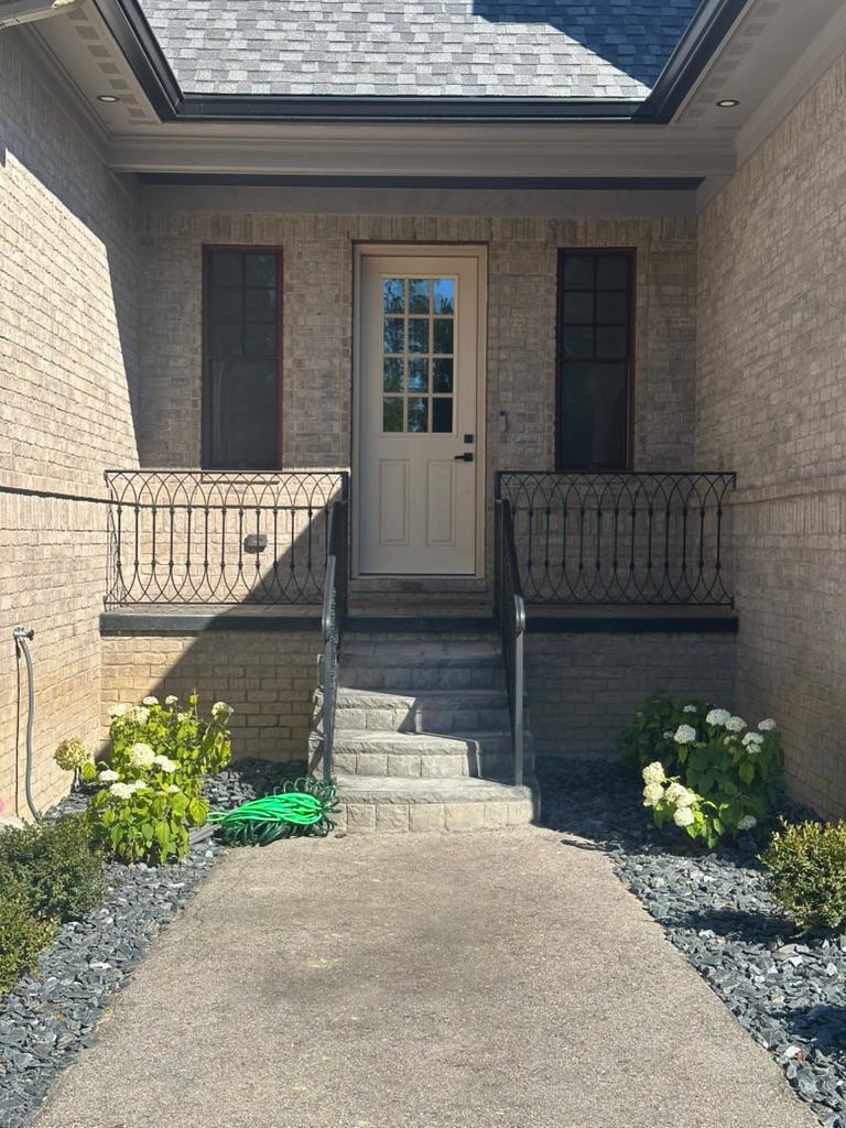Custom iron step railings on a luxury home entrance in Metro Detroit
