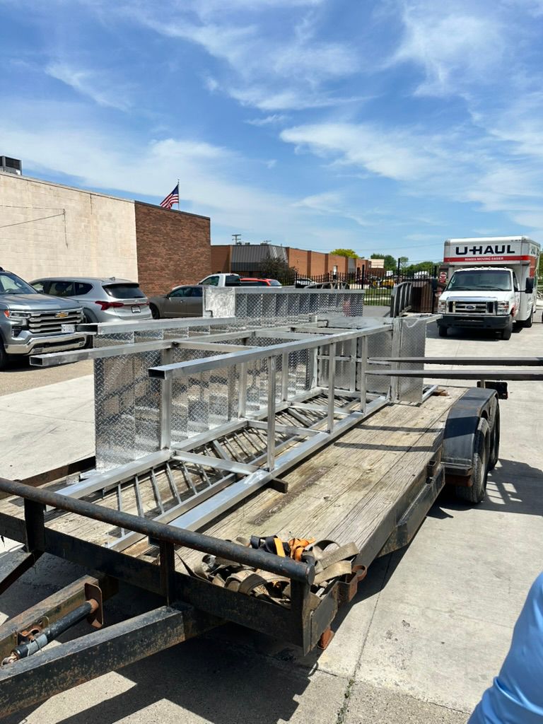Custom aluminum staircases loaded on a trailer for mobile delivery across Metro Detroit