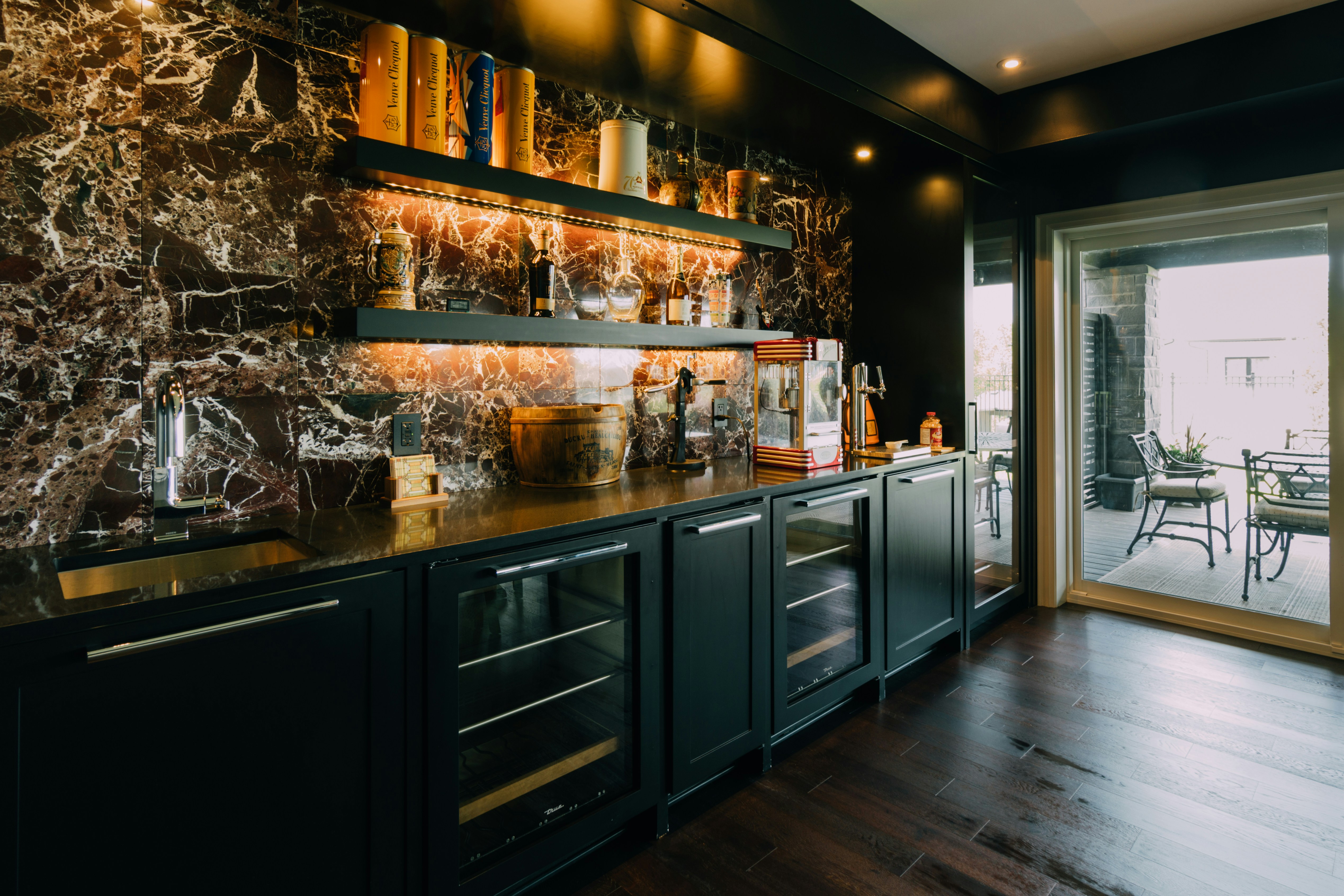 Dark Kitchen with Marble Backsplash and Open Shelving