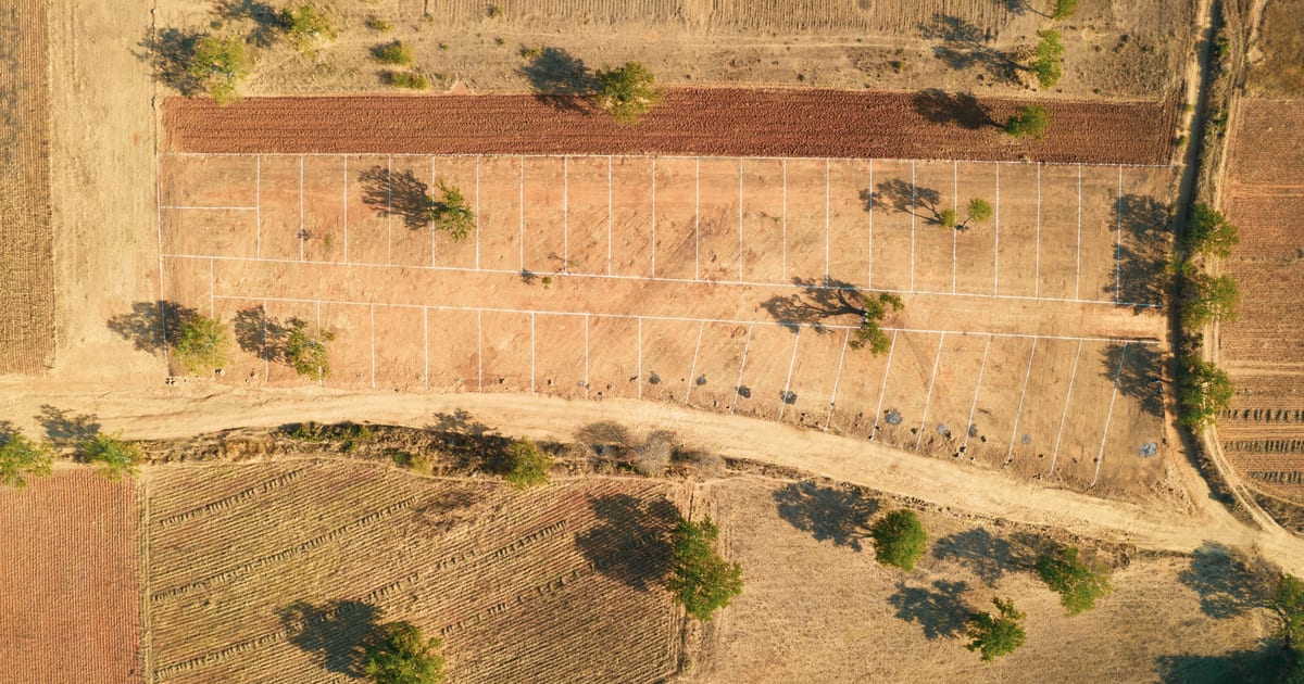 Aerial view of Canadian rural farmland and open fields being assessed for a land loan