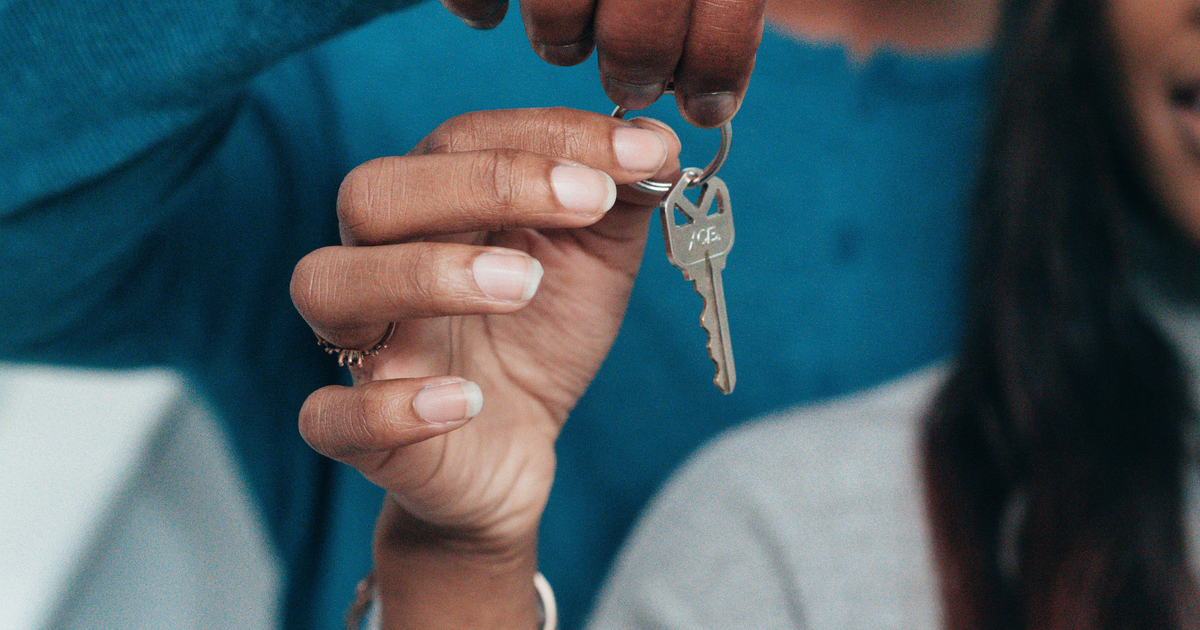 Canadian homeowners holding house keys after rebuilding credit following a consumer proposal