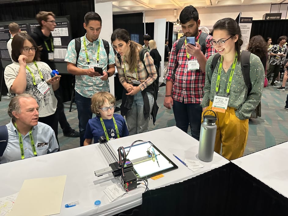 People admiring a pen plotter