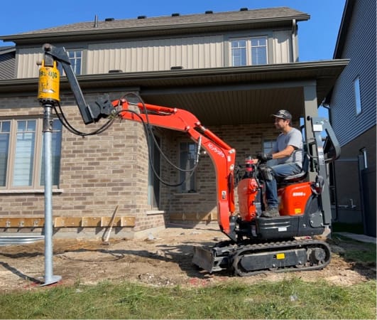 Helical pile installation on a residential site