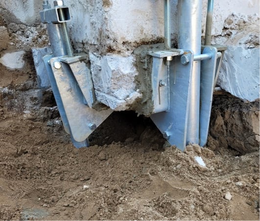 Helical pile underpinning repair on an existing foundation