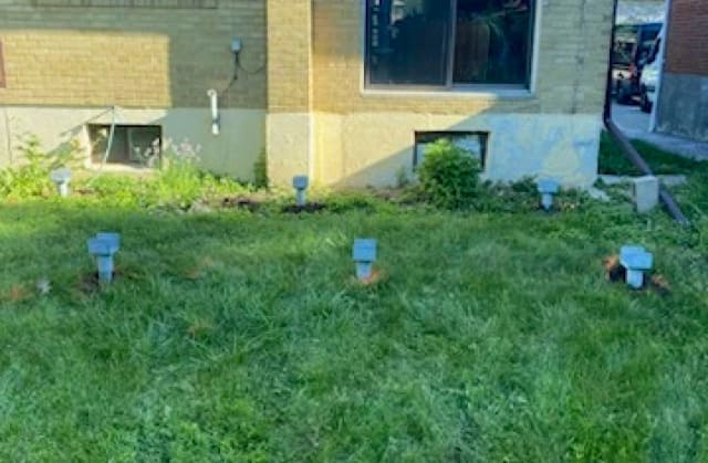 Helical pile caps installed in a yard