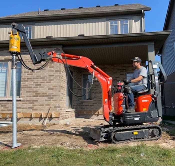 Liberty Helical Piles machine installing a helical pile on a residential site