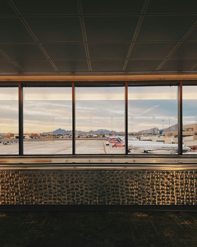 Phoenix Sky Harbor airport terminal window view with mountains and planes on the tarmac