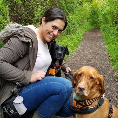 Puri posing with 2 dogs while out on a walk.