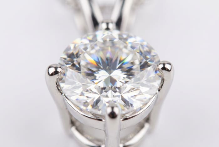 Four Prong Diamond Solitaire Pendant — macro close-up of round brilliant diamond