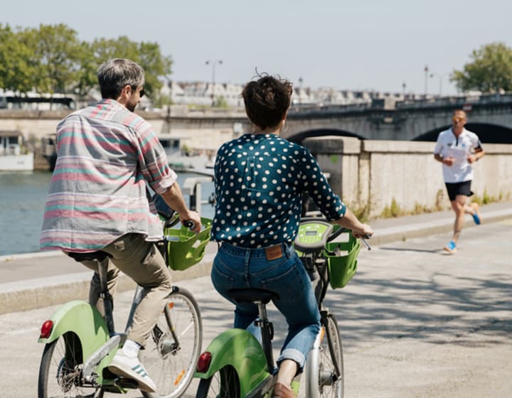 Couple cycling on the banks of the Seine, Paris