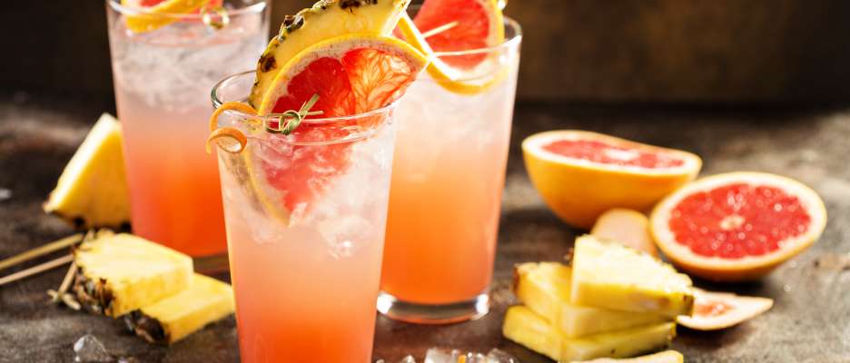 Three grapefruit and pineapple cocktails