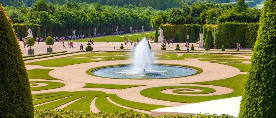 Visitors enjoying a sunny day at the National Park of Versailles.